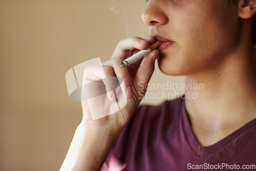 Image of Teenager, hand and cigarette closeup for smoking student unhealthy habit, dangerous or addiction. Male person, fingers and tobacco risk or stress management for lungs pain, bad quit problem of cancer