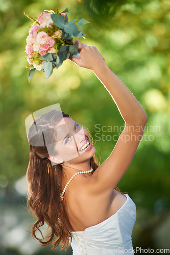 Image of Woman, throwing and wedding rose bouquet with love, commitment and trust ceremony for marriage. Engagement, celebration and flowers for event in a park with a red floral plant and bride dress outdoor