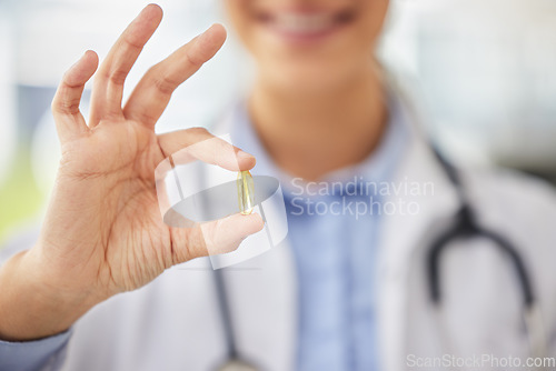 Image of Doctor, closeup and hand for medicine capsule with smile with ok sign, promotion and feedback for choice. Medic person, pharmaceutical product and show for wellness, healthcare or omega 3 in clinic