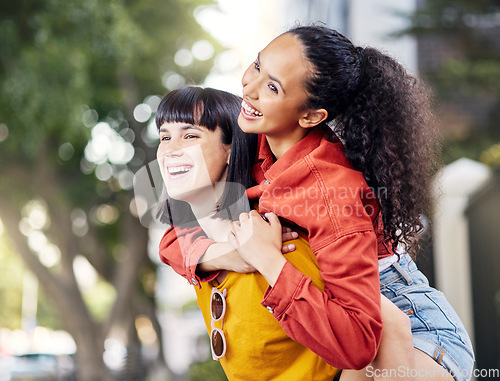 Image of Couple of friends, lesbian and piggyback outdoor for fun, travel and happiness or love on vacation. Young female people in a city for holiday or playful trip with a smile and joy to hangout in summer