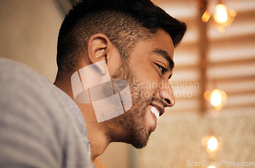 Image of Man, face and happy with thinking or closeup for ideas, positive mindset and inspiration in cafe. Indian person, smile and thoughtful in restaurant with confidence, pride and satisfaction or cheerful