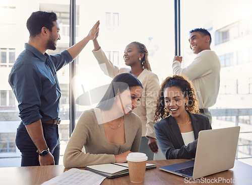 Image of People, high five and success in office with teamwork, collaboration and support for work in startup. Group, celebration and achievement of goals or kpi challenge in workplace and employees on laptop