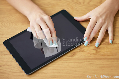 Image of Hand, cleaning tablet and cloth for screen, dust and dirt with shine on glass, hygiene or disinfection in home. Woman, digital touchscreen and fabric, wipe or sanitation for bacteria, virus or health