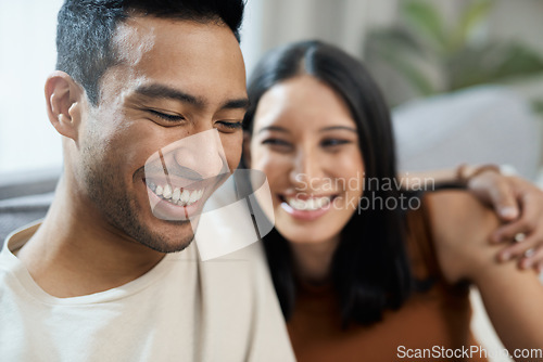 Image of Couple, face and happy on sofa with love, bonding and relax for relationship in living room of home. Care, woman and man with smile on couch in lounge of house for peace, embrace and freedom or laugh