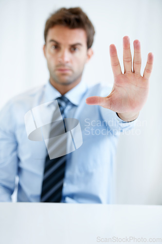 Image of Businessman, hands and stop for wait, no or halt in gesture, protest or take a stand at office. Man, male person or employee showing palm for negative sign, disapproval or disagree at workplace