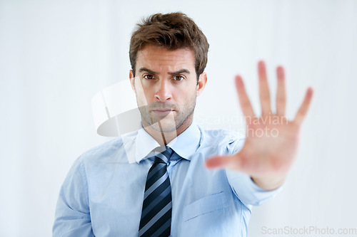 Image of Businessman, portrait and hands stop for wait, no or halt in gesture, protest or take a stand at office. Man, male person or employee show palm for negative sign, disapproval or disagree at workplace
