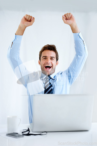 Image of Business man, winner and computer for trading success, achievement or winning of bonus, sales or profit. Excited portrait of a trader with fist, yes and celebration on laptop and a white background