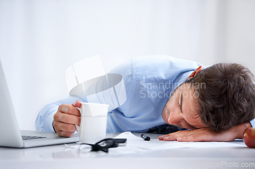 Image of Business man, sleeping and tired at work, burnout and exhausted or mental health, desk and overwhelmed. Male person, dreaming and lazy in office, resting and fatigue or low energy, coffee and nap