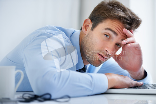 Image of Tired, desk and portrait of business man in office on laptop working on deadline, project and online report. Corporate, burnout and face of exhausted, fatigue and overworked employee on computer