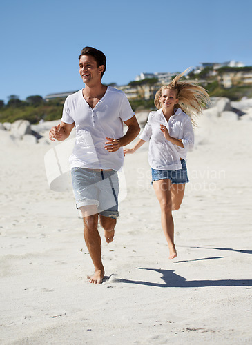 Image of Couple, running and summer on beach, smile and outdoor in sunshine for vacation, adventure and travel. Man, woman and happy on sand for love, bonding and holiday by sea with exercise in Naples, Italy