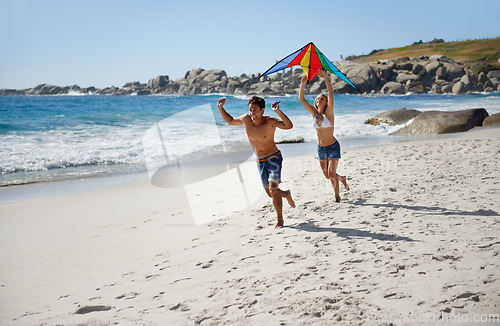 Image of Couple, running and happy with kite, beach and summer sunshine for vacation, freedom or play in air. Man, woman and happy to launch wind toys, bonding or holiday by sea for adventure in Naples, Italy