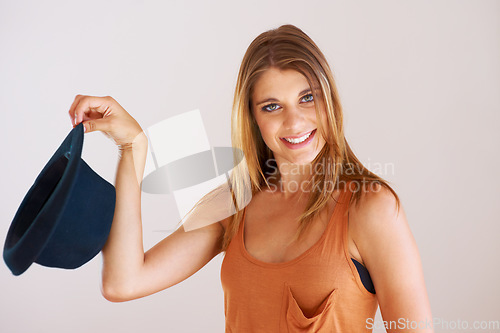 Image of Portrait, woman and smile with hat in studio for fashion, confidence and good mood isolated on white background. Happy, young and cool model with fedora accessory, gen z style or pride in personality