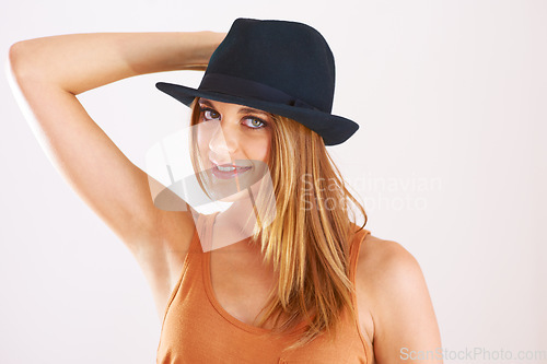 Image of Portrait, woman and smile with hat in studio for fashion, confidence and good mood isolated on white background. Happy, young and cool model with fedora accessory, summer style or hipster personality