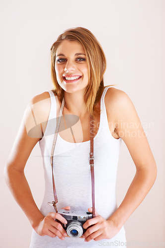 Image of Smile, portrait and woman with camera in studio for photography, memory or nature on white background. Face, happy and female photographer with equipment for creative hobby, career or shooting