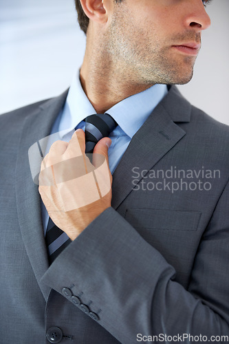 Image of Job opportunity, tie and a business man getting ready for work in studio on a white background. Corporate, company and dressing with a young employee adjusting his outfit for a professional career