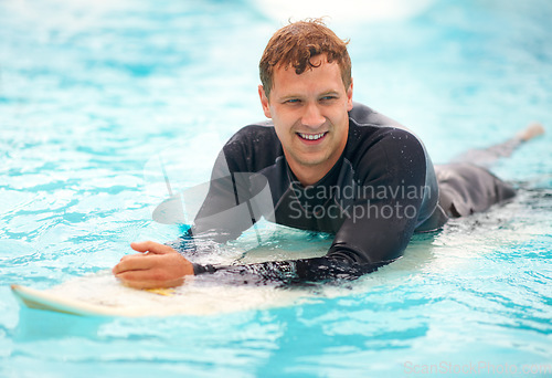 Image of Young, man and surfer in ocean with board, health fitness and happy in summer with water sports. Person, smile and relax wellness in caribbean beach with vacation, adventure and wetsuit for workout