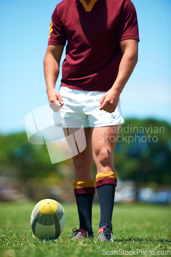 Image of Legs, athlete and player with rugby ball for sports workout or training on a field. Feet, fitness and man ready for competitive exercise in a uniform for sporty fun with an active game outdoors