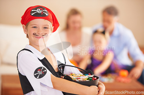 Image of Boy, portrait or candy for halloween in home, face paint or happiness in childhood. Son, chocolates and family on holiday for trick o treat, pirate costume and love in celebration together in house