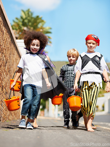 Image of Halloween, children or trick and treat portrait outdoor in neighborhood for fun and dress up. A group of young kids together for happiness, celebrate holiday and diversity with candy or sweets