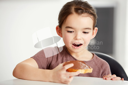 Image of Little girl, toast and chocolate spread for sweet, delicious or desert snack on bread in kitchen at home. Young female person, child or kid in surprise for food or candy treat on wheat at house