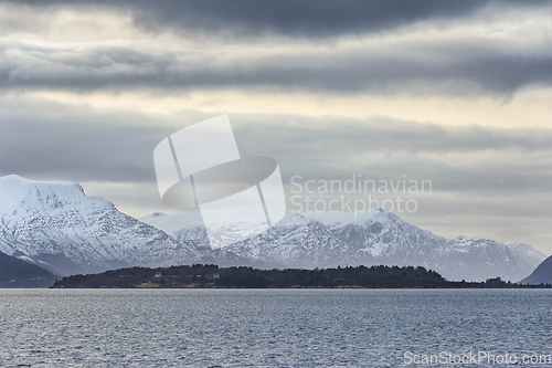 Image of Majestic Snow-Capped Mountains Dominating the Horizon at Dusk by