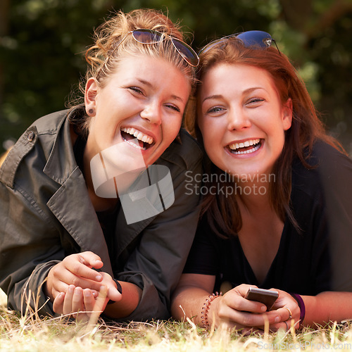 Image of Portrait, outdoor and women on the grass with smile, funny or happiness with vacation, relax or bonding together. Face, people on the ground or girls with joy, weekend break or getaway with summer