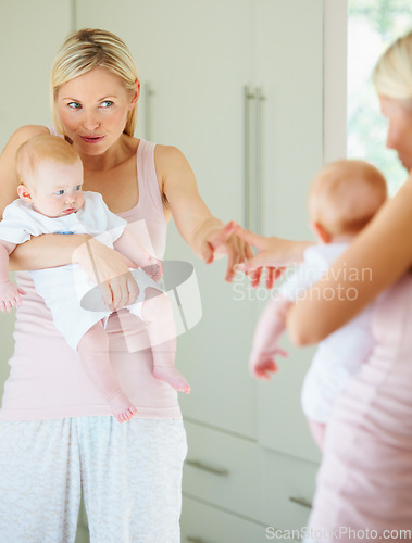 Image of Mother, baby and love in mirror, care and hug in reflection, home and learning for development. Mom, child and bonding or embrace, security and family or play, motherhood and creative education