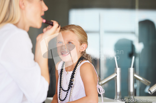 Image of Mother, child and smile for cosmetics, makeup and support in bathroom, lipstick and fun at home. Mom, daughter and learning or play, beauty and skincare or bonding, love and teaching or grooming