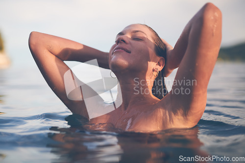 Image of Ocean, swimming and woman with sea, happiness and relax with getaway trip, freedom and outdoor for fun. Person, traveller and girl with holiday, water and summer with weekend break, tourism or travel