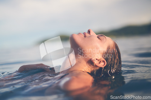 Image of Ocean, swimming and woman with holiday, sea and relax with getaway trip, freedom and outdoor for fun. Person, traveller and girl with vacation, water and summer with weekend break, carefree or travel