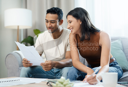 Image of Happy couple, documents and finance on sofa in budget planning, expenses or bills together at home. Man and woman smile with paperwork in living room for loan, financial plan or insurance at house