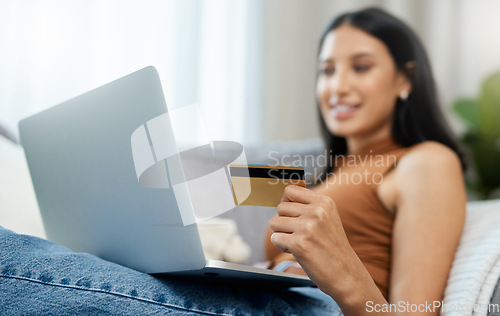 Image of Laptop, credit card and woman on sofa for online shopping, e commerce and digital payment or order at home. Relax person on computer with internet banking, security numbers or registration for a loan