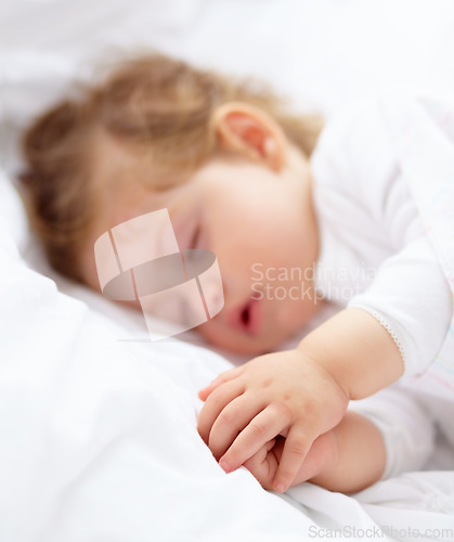 Image of Hands, baby and kid sleeping on bed for calm break, peace and dreaming to relax at home. Tired, young child and cozy nap for newborn development, healthy childhood growth and rest in nursery room