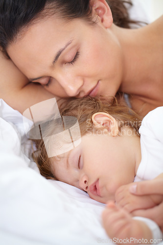 Image of Mom, baby and kid sleeping on bed together for calm break, peace or dreaming to relax at home. Face of tired mother, young child and cozy nap for newborn development, healthy childhood growth or rest