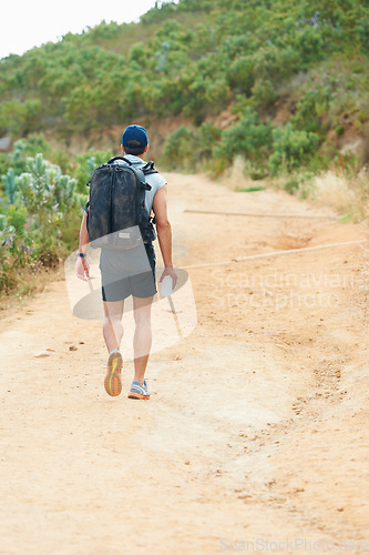 Image of Fitness, back or man hiking in nature with water, backpack or energy drink for workout, training or exercise freedom. Hiker, Brazil or walking on mountains path for health, wellness or summer sports