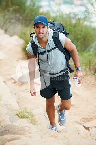 Image of Portrait, hiking and man with nature, fitness and exercise with wellness, fresh air or challenge. Person, hiker or guy with backpack, hobby or activity with workout, training or endurance with travel
