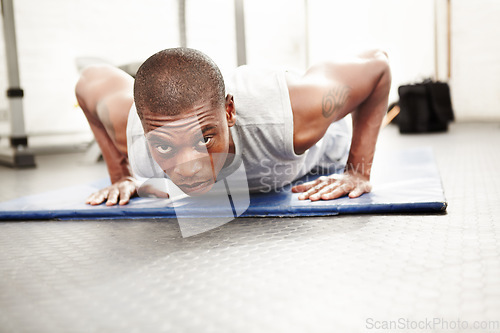 Image of Black man, gym and push up at a wellness club with exercise, fitness and workout with strength. Power, floor and African male athlete with training strong arms on the ground for health and sport