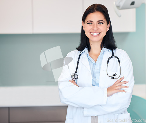 Image of Happy woman, doctor and portrait of medical professional or dentist with arms crossed and stethoscope. Female person, surgeon or qualified healthcare expert smile in confidence at hospital clinic