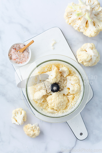 Image of Preparing  cauliflower rice in a food processor, cauliflower in a blender.