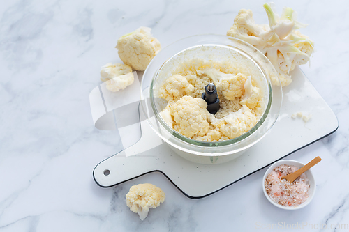 Image of Preparing  cauliflower rice in a food processor, cauliflower in a blender.