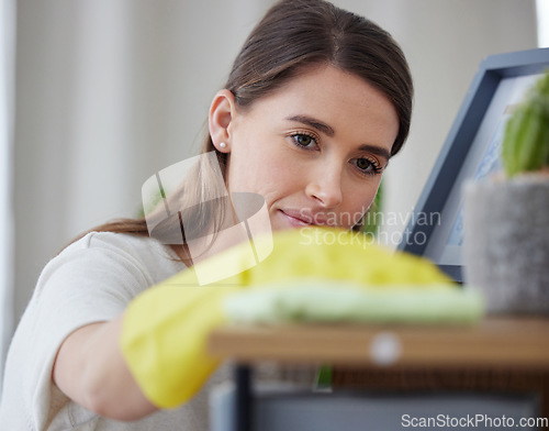 Image of Woman, cloth and home for cleaning table with check, vision and hygiene with gloves in living room. Girl, cleaner and services with ppe, fabric and product for dust, shine and stop bacteria in house
