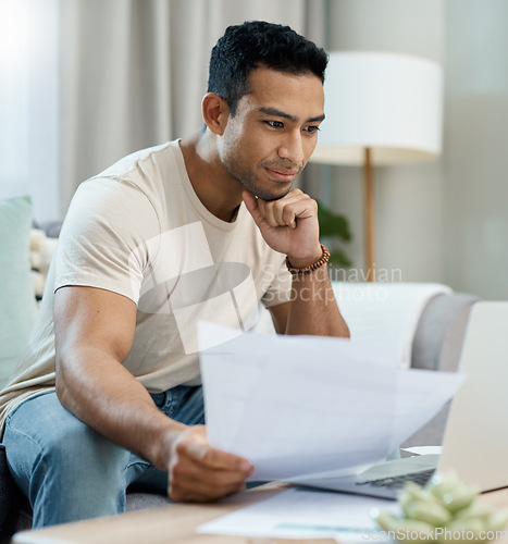 Image of Home, bills and man on laptop thinking of finance, reading website and taxes or asset management on sofa. Young person with documents for mortgage, budget solution and insurance choice on computer