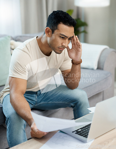 Image of Man, bills and headache on laptop and sofa for finance mistake, debt review or taxes stress at home. Young and confused person with documents for budget fail, bankruptcy or inflation news on computer