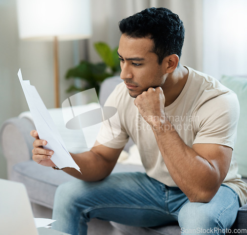 Image of Serious man, documents and thinking for debt or planning in decision on living room sofa at home. Male person with paperwork in thought or choice for financial plan, expenses or bills at house