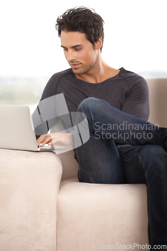 Image of Relax, laptop and online with man on sofa for social media, networking and connection. Website, streaming and digital with person in living room at home for remote work, research and technology