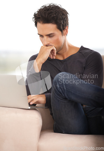 Image of Man, work from home and thinking on laptop for stock market investment, reading information or website on sofa. Freelancer or trader on his computer with trading software, choice or online decision