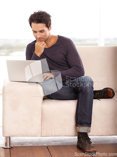 Image of Man, work from home and thinking on computer for stock market investment, reading information or website on sofa. Freelancer or trader on his laptop with trading software, choice or online decision