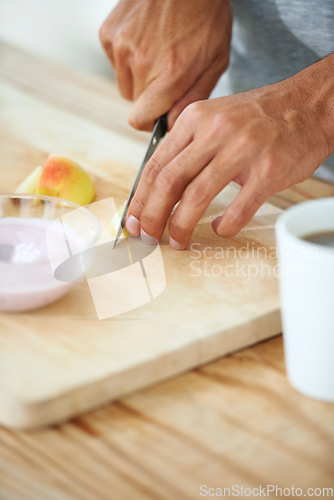 Image of Hands, knife and fruit cutting in morning breakfast or diet nutrition, wellness health or vitamin fiber. Fingers, cutlery and apple preparation or vegan meal as weight loss, yogurt on kitchen counter