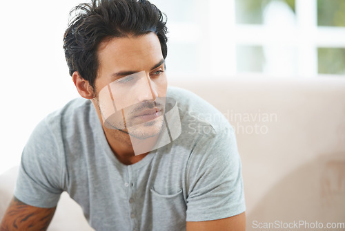 Image of Thinking, depression and face of man on sofa with stress, anxiety or broken heart at home. Fail, crisis or male person in living room overthinking, disaster or lonely, worry or disappointed in house