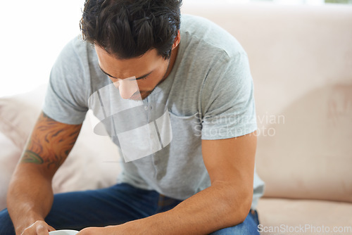 Image of Thinking, depression and sad man on a sofa with stress, anxiety or broken heart at home. Fail, crisis or male person in living room overthinking, disaster or lonely, worried or disappointed in house